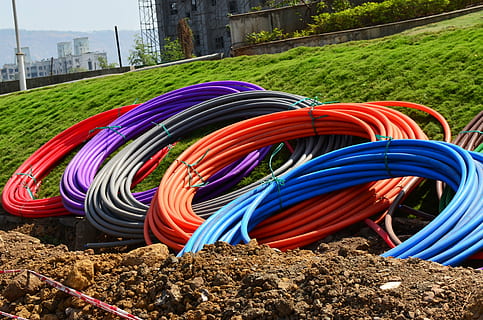 assorted-color hoses on green grass field, conduit, pipes, coils HD wallpaper