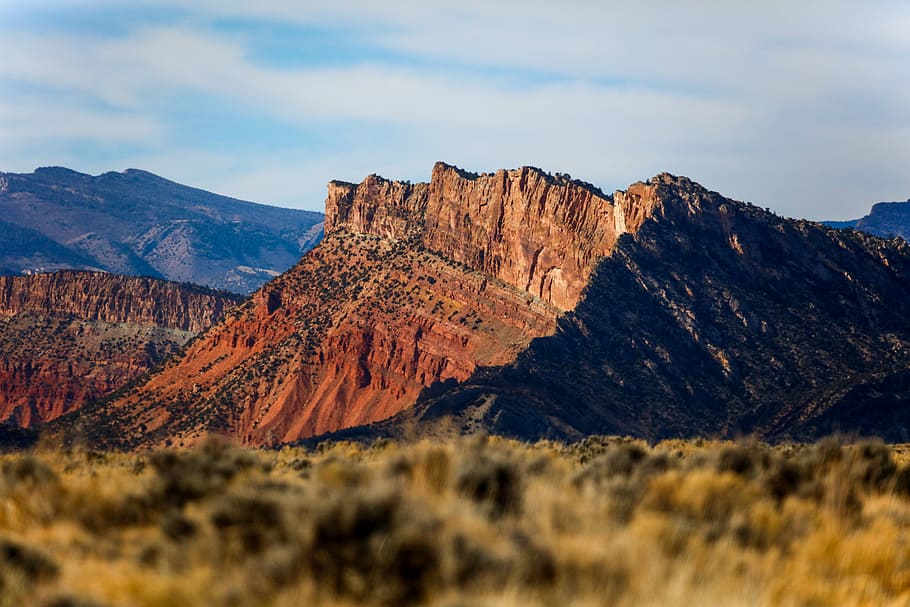 black and brown mountain, brown mountain under cloudy sky during daytime HD wallpaper