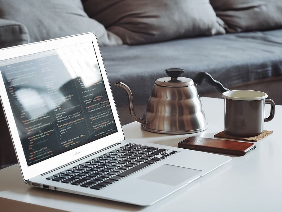 turned on MacBook Air beside black smartphone and black ceramic mug, laptop, mug, phone, and teapot on table HD wallpaper