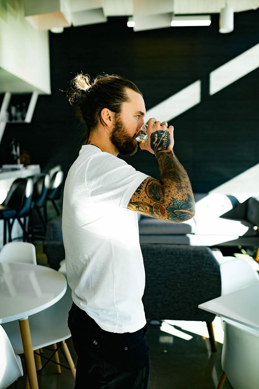 Tattooed man drinking, man drinking glass of water, male tattoo