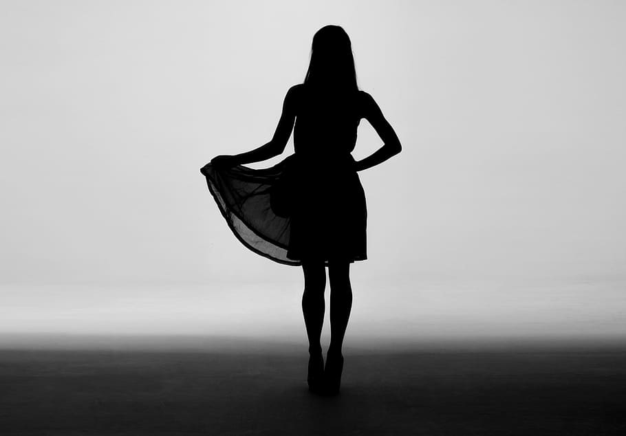 silhouette of woman holding skirt of dress, silhouette of a woman wearing dress