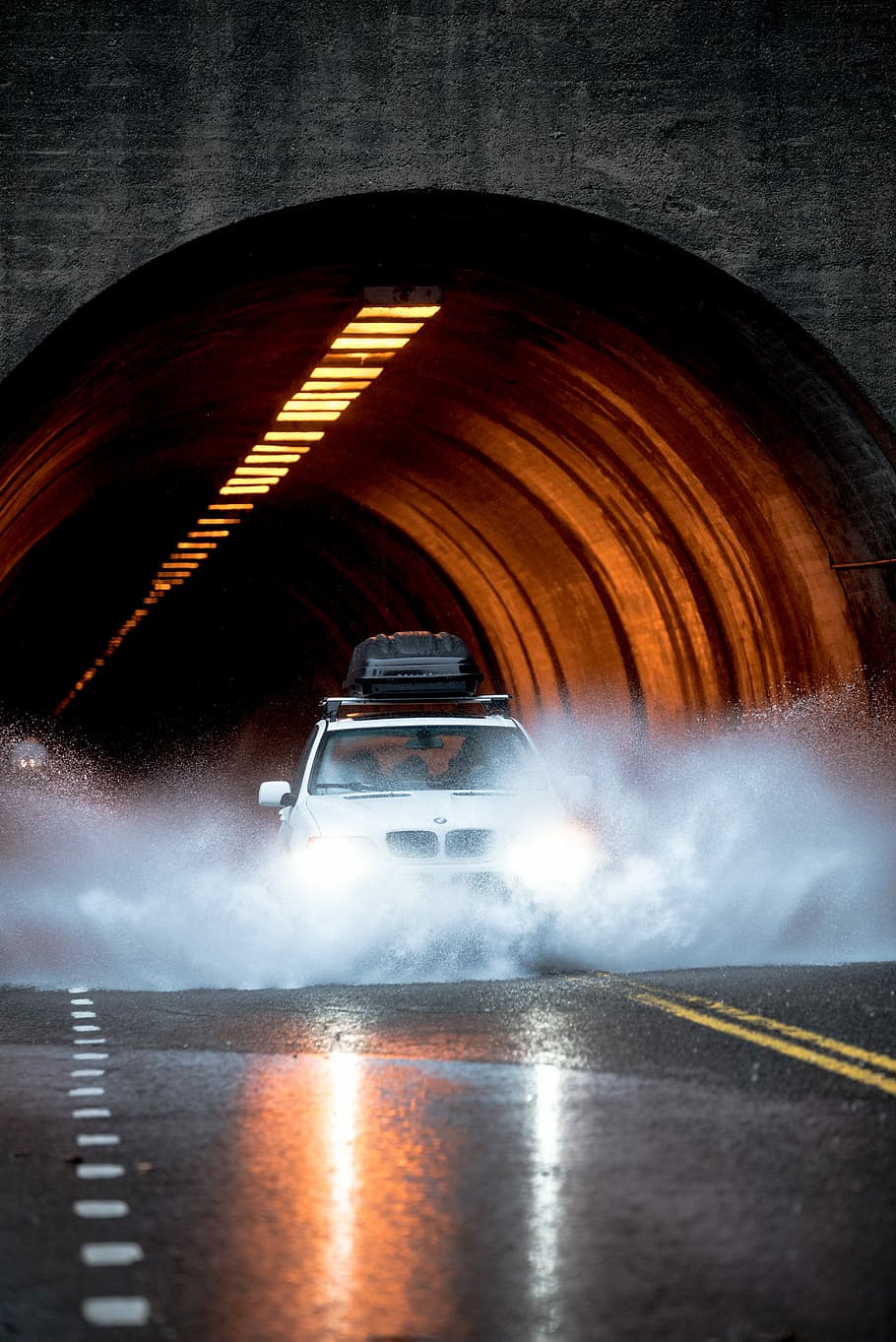 white BMW car crossing asphalt road in front of concrete tunnel, white BMW SUV on road HD wallpaper