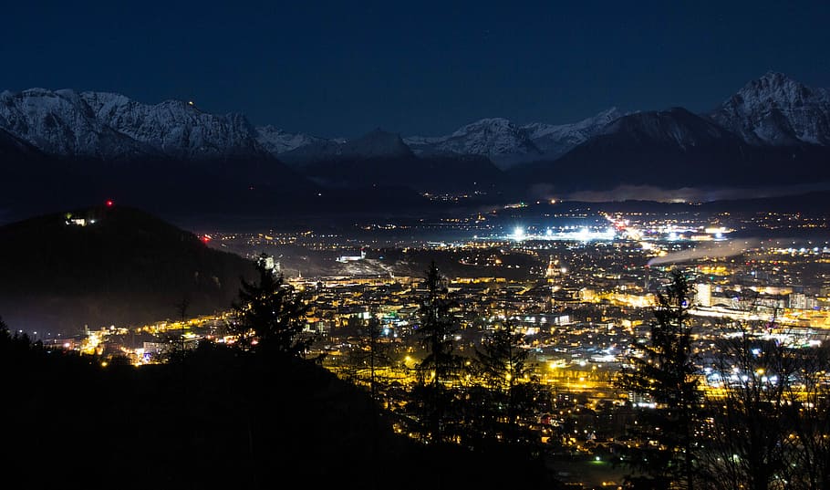lighted cityscape near mountain at nighttime, Alpine, Snow HD wallpaper
