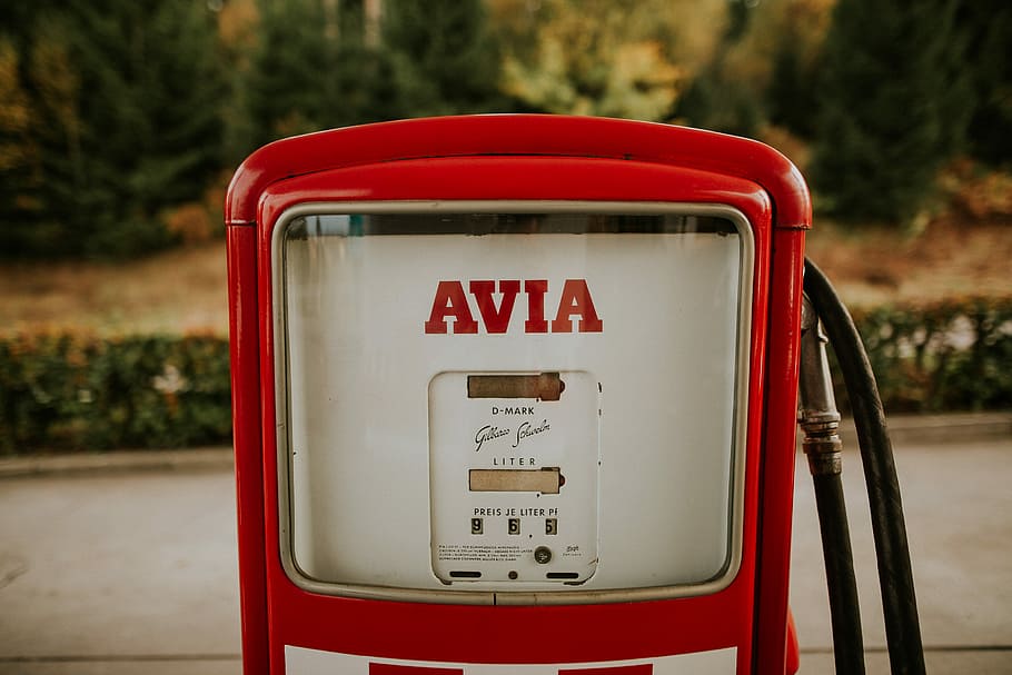 shallow focus photography of white Avia gas pump, red and white Avia gas station