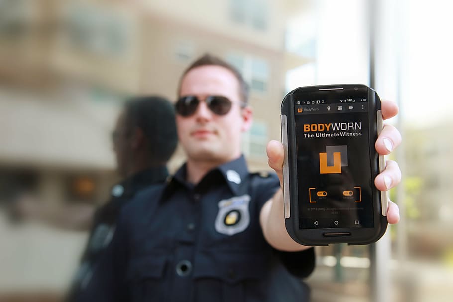 man holding smartphone, bodyworn, body camera, police body camera