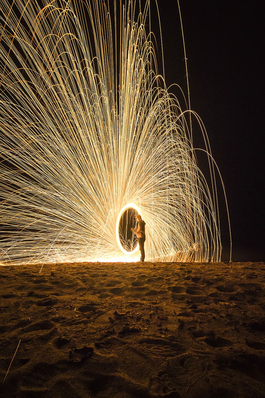 person holding fireworks on beach during nighttime, lights, spark, HD wallpaper