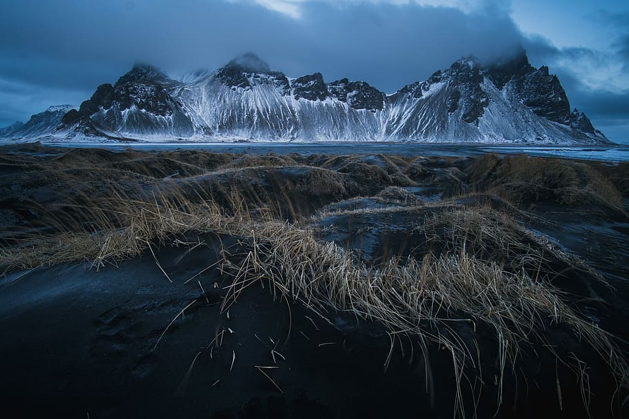 brown grass field in distance glacier mountain at daytime, landscape photography of mountain covered with snow HD wallpaper