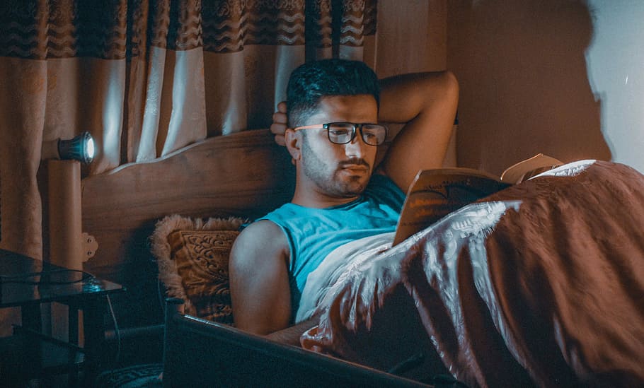 man reading book lying on bed, glasses, one person, adult, indoors HD wallpaper