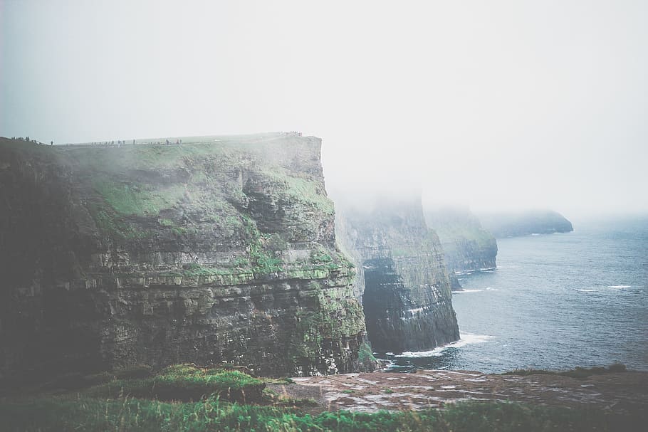 rock formation near body of water during foggy day, cliffs, the cliffs of moher