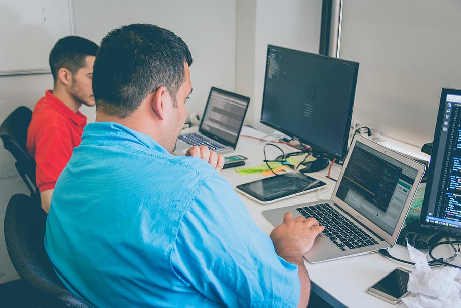 two men using laptop, man sitting on chair front of laptop, male