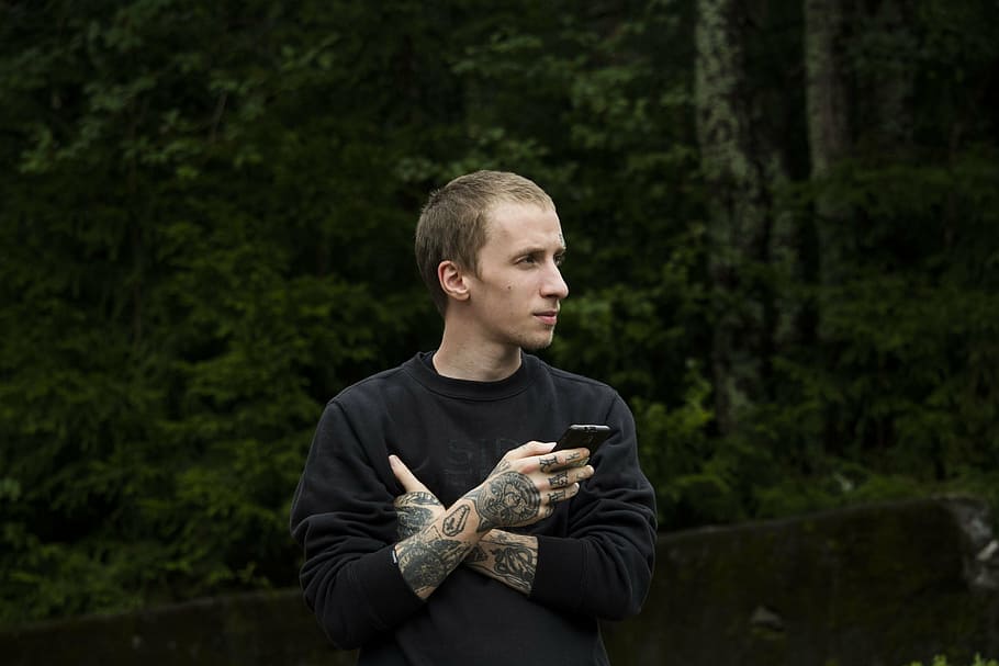 man in black sweatshirt, tattoo, forest, guy, person, youth HD wallpaper