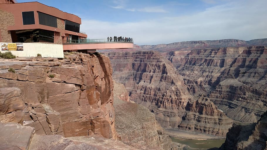 Skywalk on the Hualapai Reservation, orange concrete building near rock formations at daytime HD wallpaper
