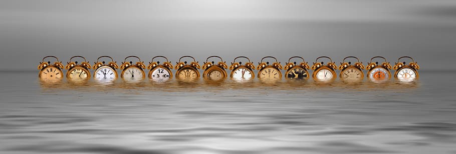 assorted-color twin bell alarm clocks floating in body of water, HD wallpaper