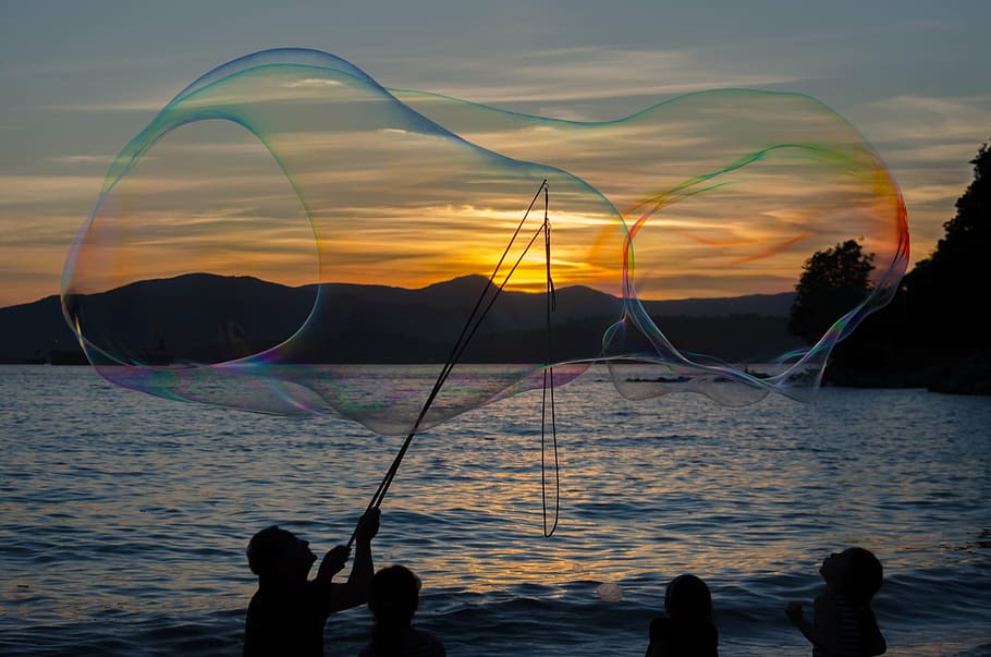 silhouette of man making large bubbles during sunset, life HD wallpaper