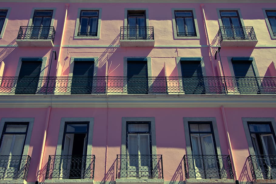 Wide-angle shot of a pink-coloured building in Lisbon, Portugal HD wallpaper