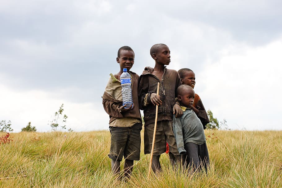 boy wearing yellow top on green grass field, children, burundi