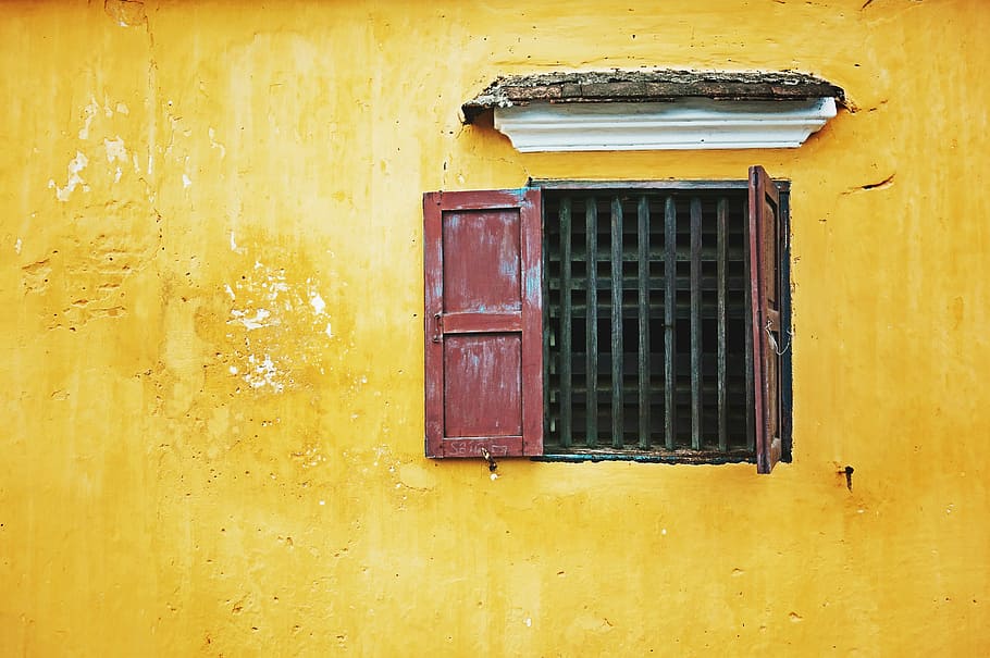 red wooden door, brown wooden open window, yellow, wall, red shutter