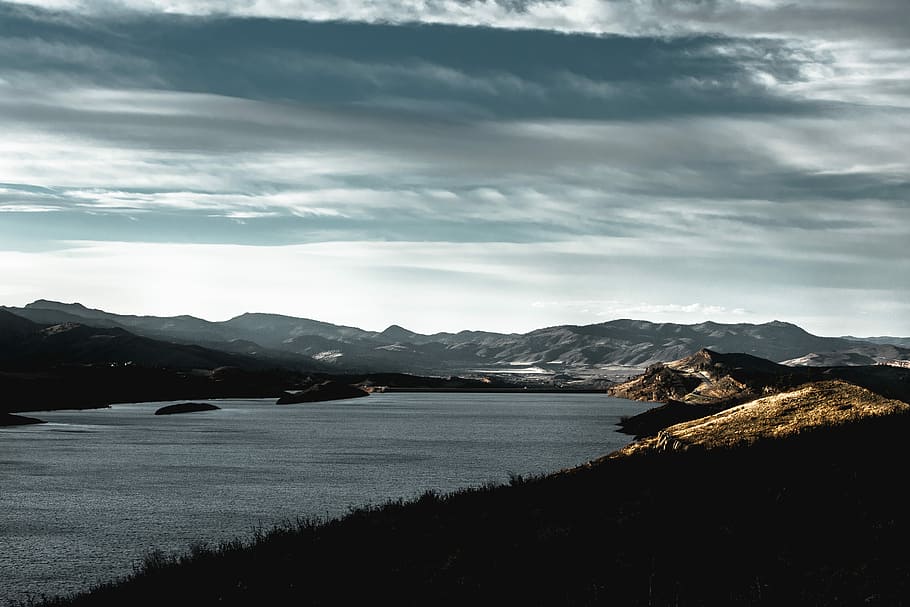 photo of mountains during sunrsie, aerial photography of body of water surrounded by mountains HD wallpaper
