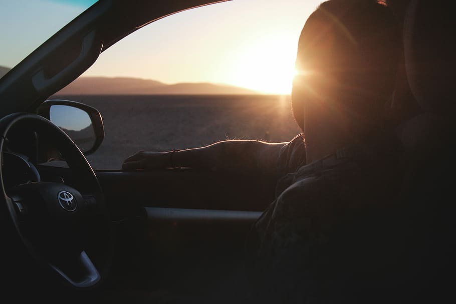 silhouette of man riding in Toyota car looking at sunset, man sitting in car staring at the sun HD wallpaper