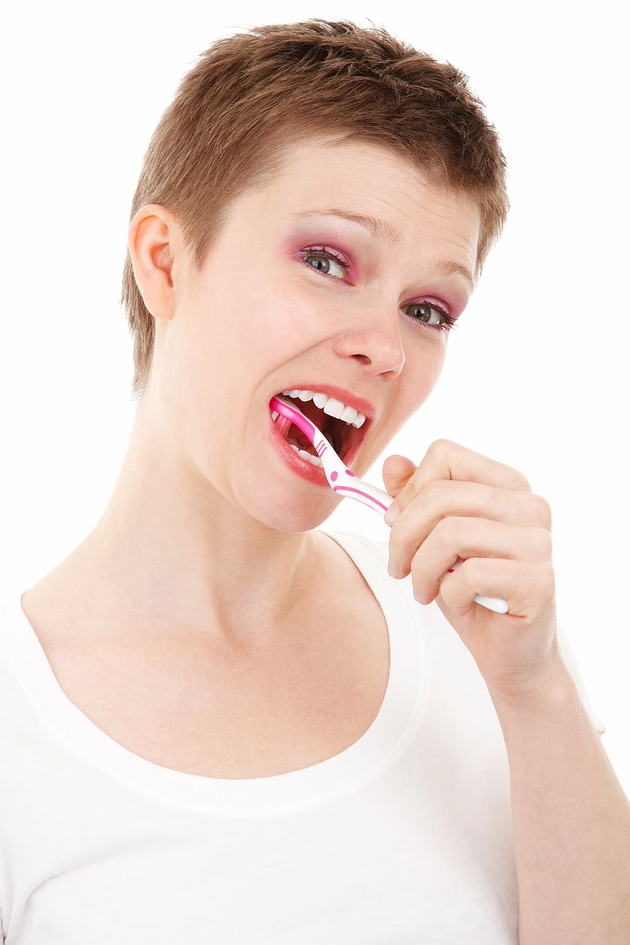 woman using white and pink toothbrush, oral, care, clean, dental