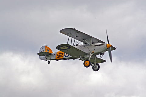 white and orange bi-plane in mid air, white and orange biplane in flight HD wallpaper