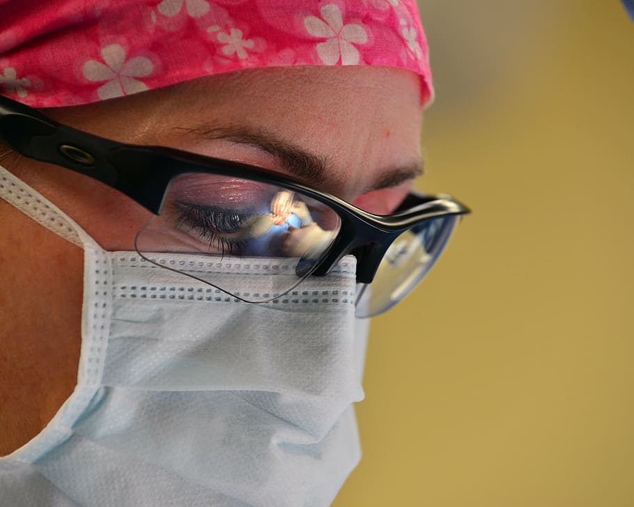 closeup photo of person wearing disposable mask, surgery, surgeon