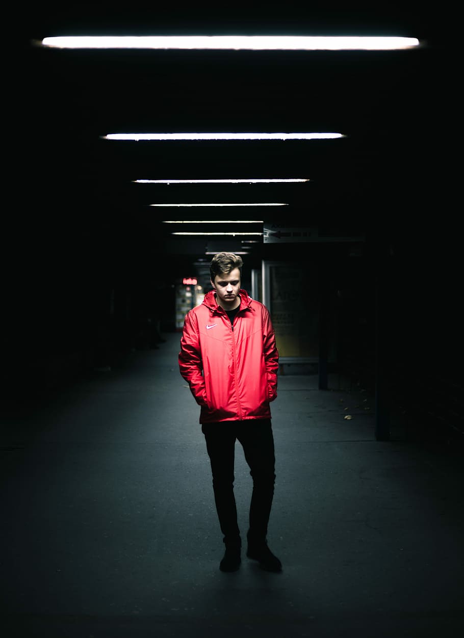 man wearing red leather jacket standing inside dark area, man wearing red zip-up jacket standing HD wallpaper