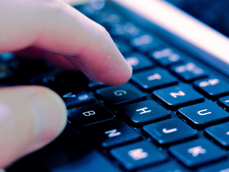closeup photo of person touching black and white laptop computer keyboard HD wallpaper