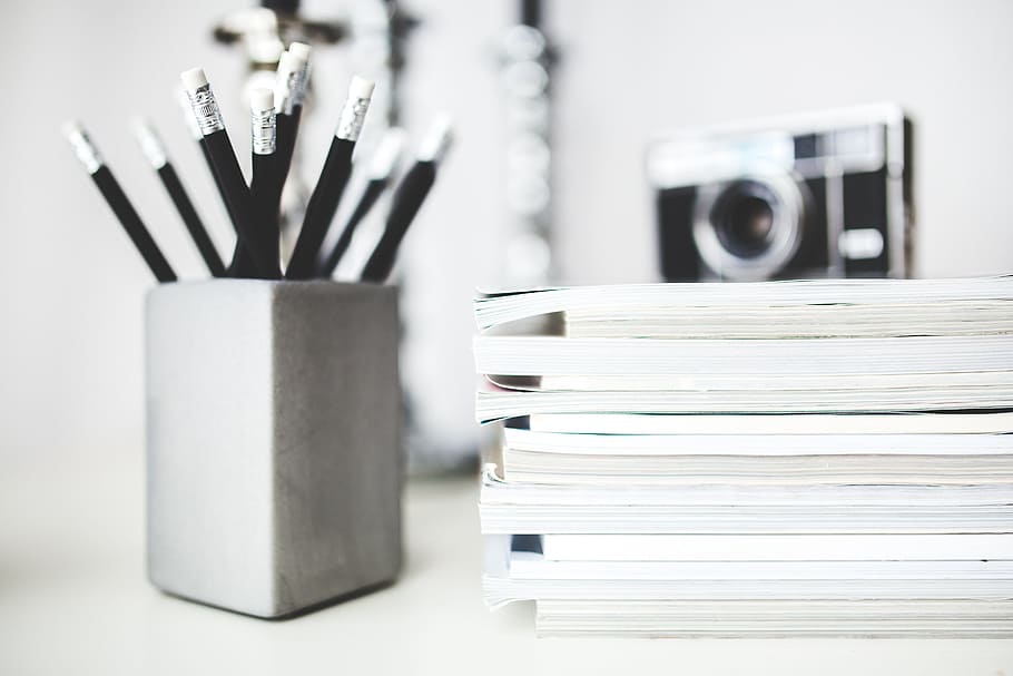 assorted books and black pencils on gray organizer, writing HD wallpaper