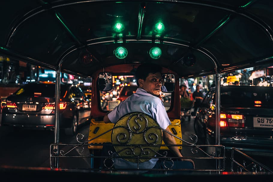 man in white collared shirt sitting in yellow and black autorickshaw between cars with taillights turned on at night, man in white polo shirt driving black and yellow auto rickshaw HD wallpaper