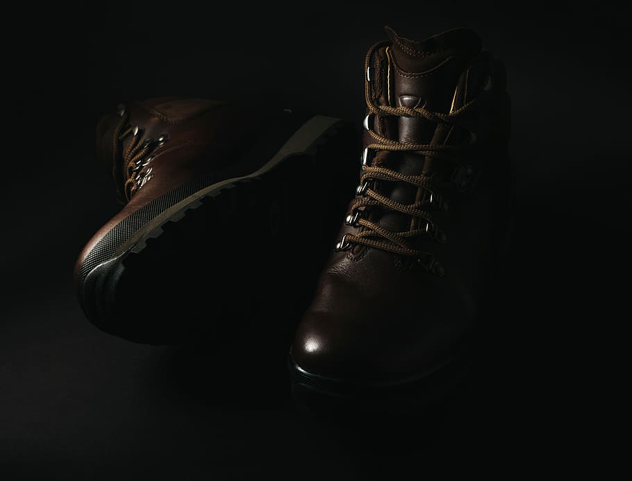 pair of brown leather lace-up combat boots, pair of brown basketball shoes