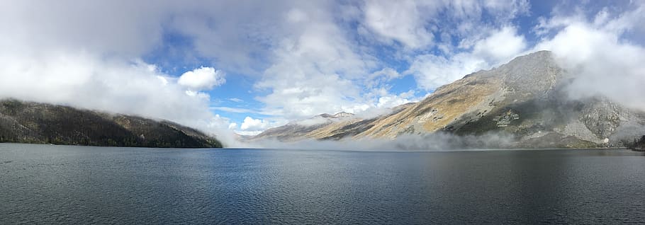 lake with background of mountain, large body of water near mountain under white clouds during daytime, HD wallpaper