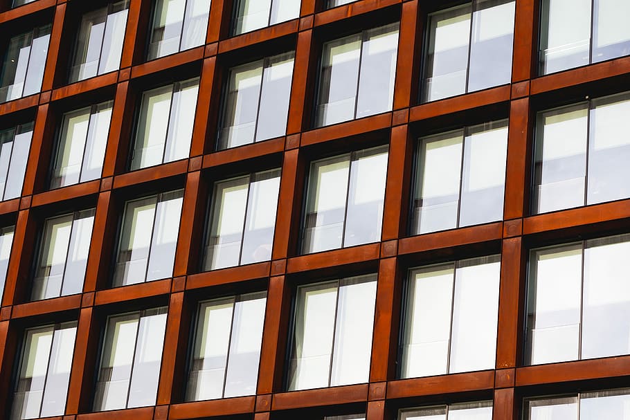 low angle photography of brown framed window, brown concrete building with glass window HD wallpaper