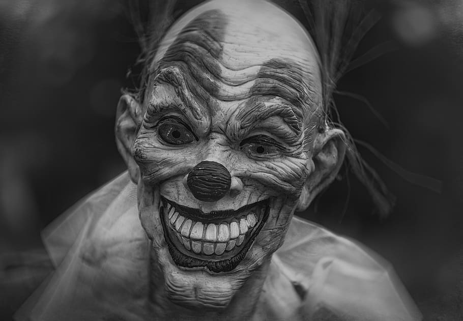 grayscale photography of person wearing clown mask, grayscale photo of clown