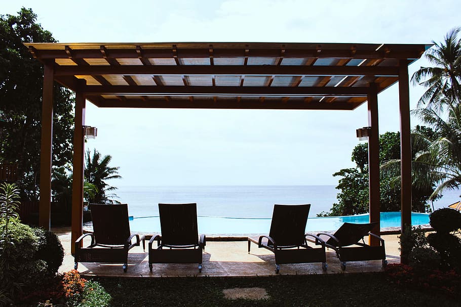 photo of four loungers under gazebo facing swimming pool, four unoccupied chaise lounges on gazebo HD wallpaper
