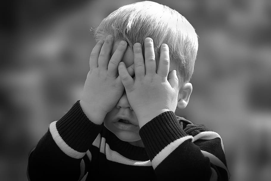 grayscale photo of boy covering his face weawring black and white striped sweatshirt HD wallpaper