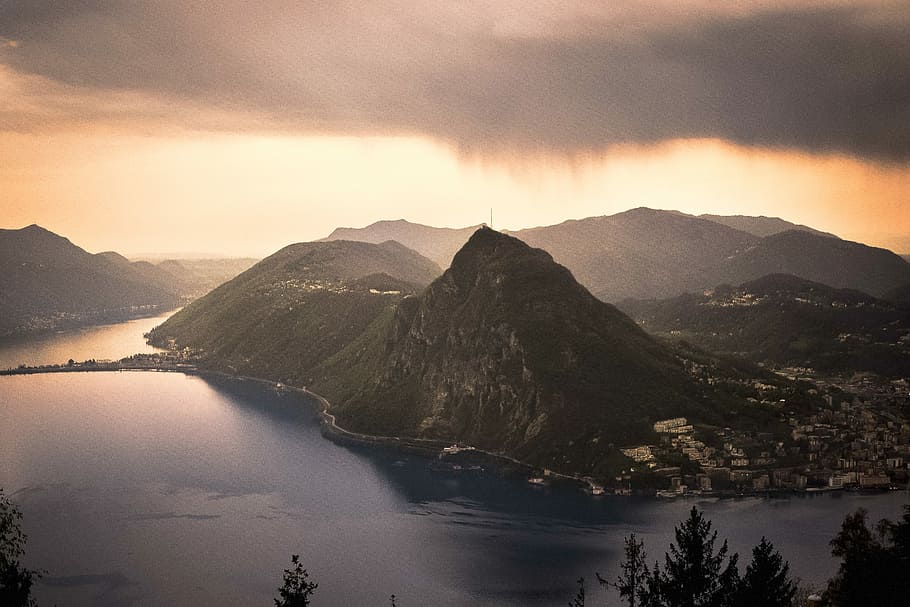 aerial photograph of mountain under gray kies, bird's-eye view of mountain and sea HD wallpaper