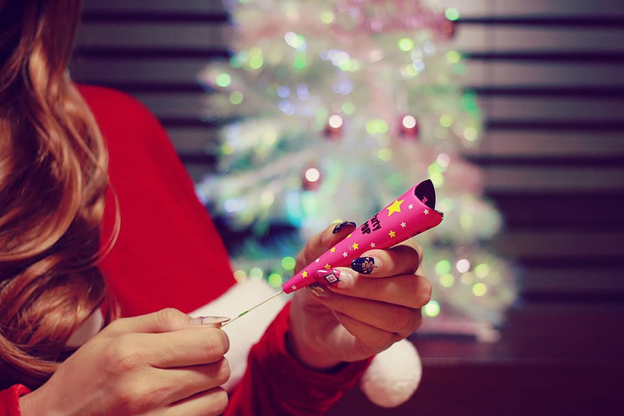 woman wearing red shirt holding pink party popper, christmas HD wallpaper