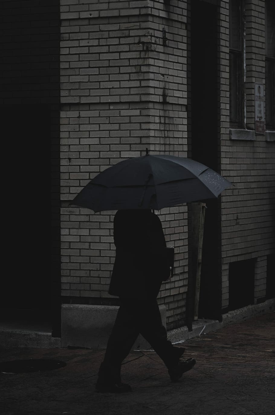 person holding umbrella walking on concrete pavement near building, man holding umbrella near wall HD wallpaper