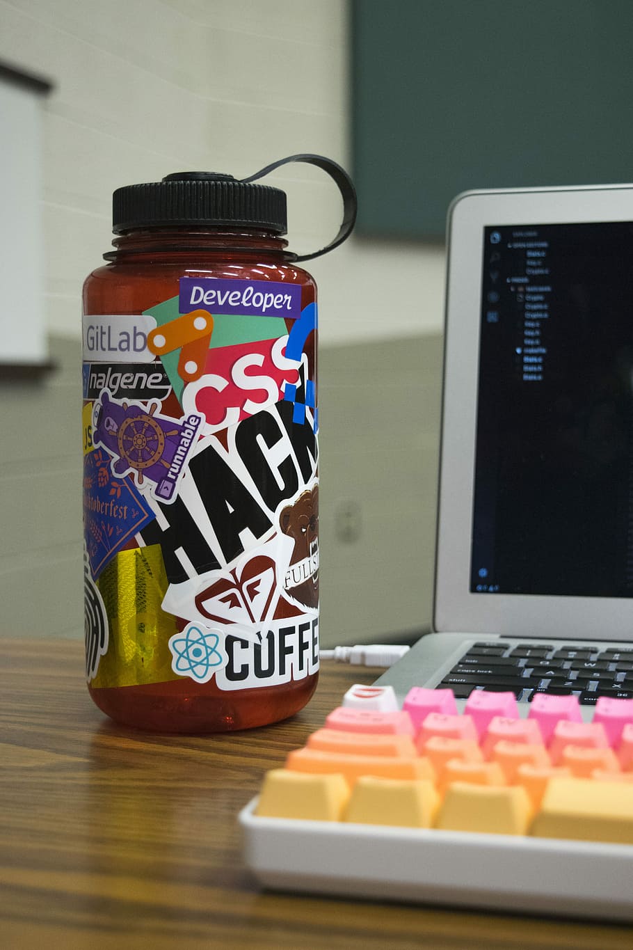 multicolored plastic bottle beside laptop, white laptop computer beside multicolored keyboard, and Developer bottle HD wallpaper