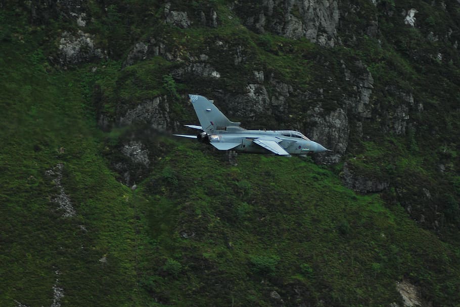 gray fighter jet near the mountain, gray jet fighter inbound