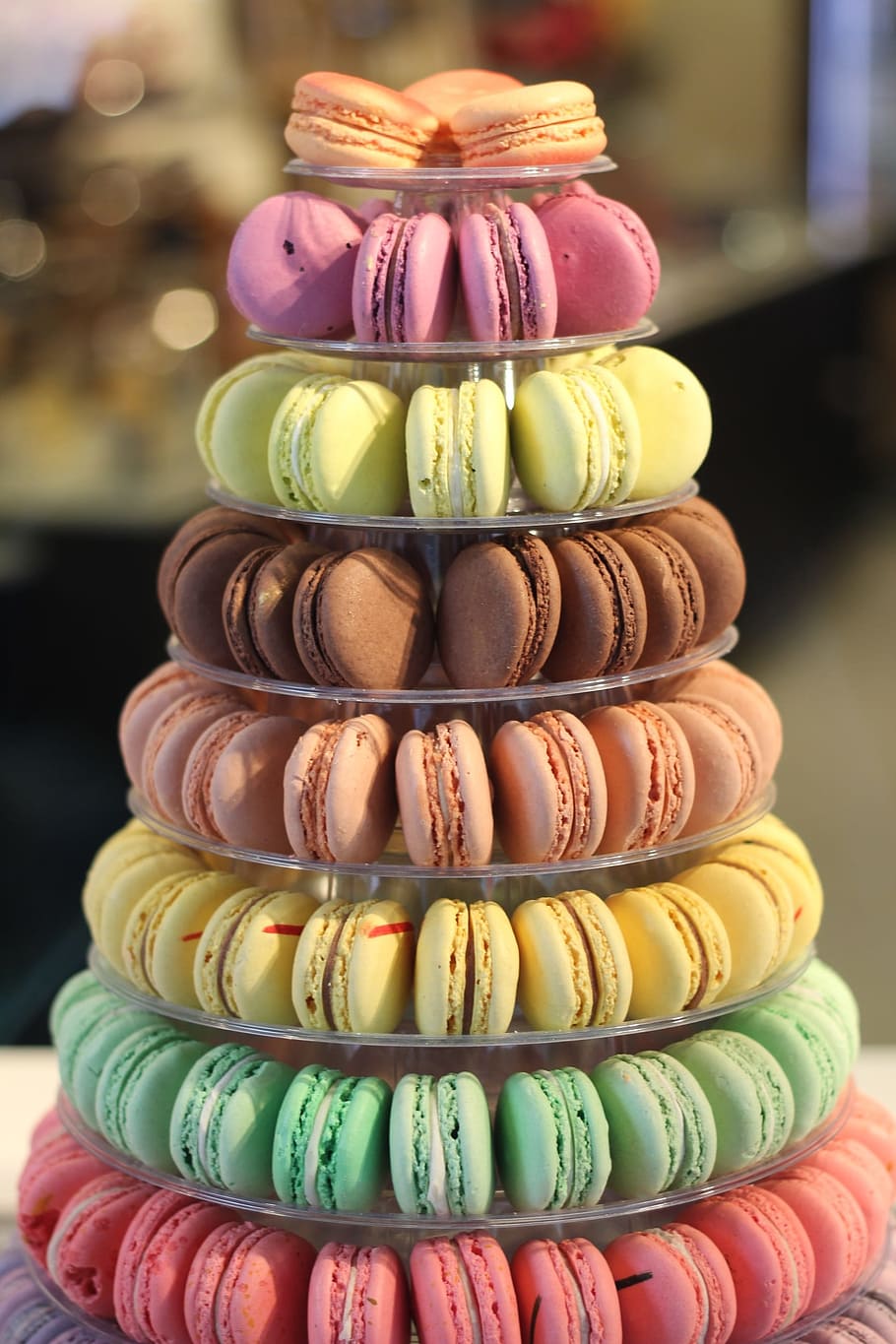 assorted-color of macarons on clear glass 8-tier tray, colorful