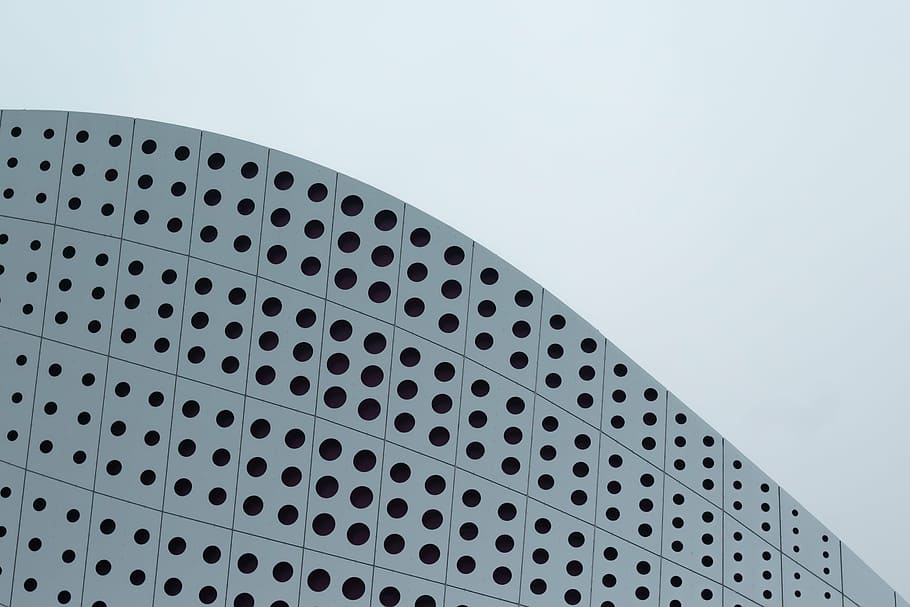 low-angle photograph of high-rise building under cloudy sky HD wallpaper