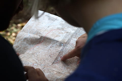 person in blue top holding white map, explore, adventure, cartography HD wallpaper