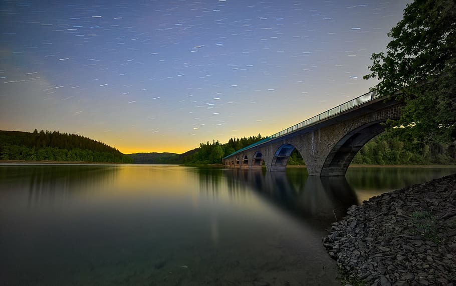brown concrete bridge, astro, startrails, night, lake, water HD wallpaper
