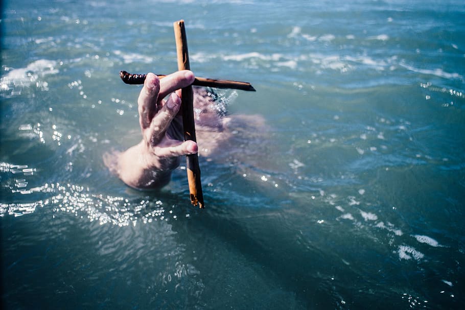 drowning person holding wooden cross, human, hand, body, water
