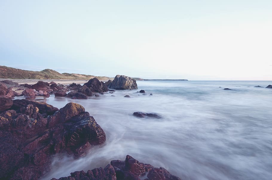 landscape photography of body of water near shore, landscape photography of rocky river near green hills under blue cloudy sky HD wallpaper