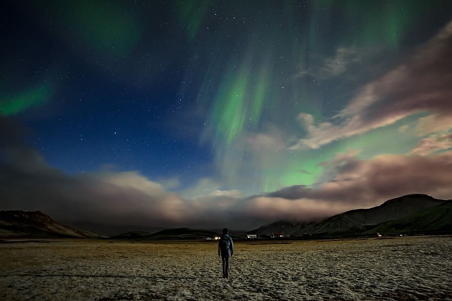 man standing near mountain under Aurora Borealis, person walking on steppe, HD wallpaper