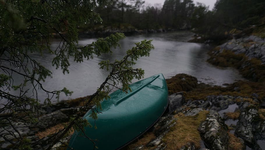 green canoe beside body of water at daytime, lake, rocks, coast