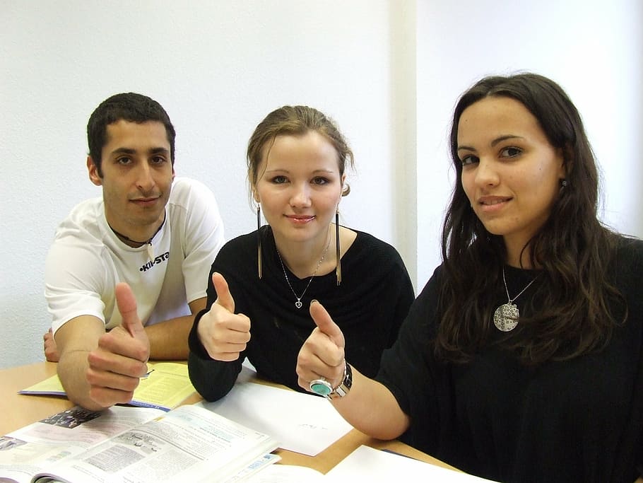 two women and one man sitting beside table, language school HD wallpaper